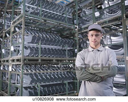 Stock Photo - Car Plant Worker With Car Parts. Fotosearch