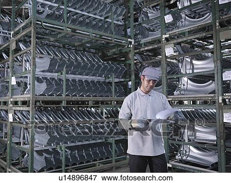 Car Plant Worker With Car Parts View Large Photo Image Stock Photo - Car Plant Worker With Car Parts. Fotosearch