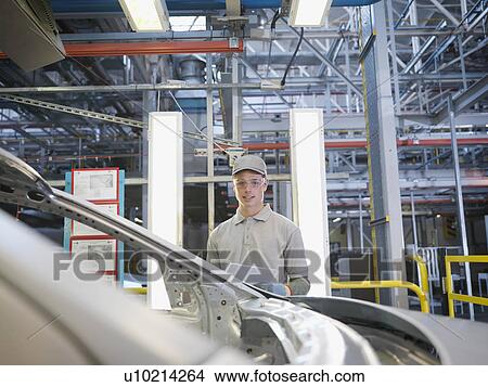 Picture - Car Plant Worker With Car. Fotosearch