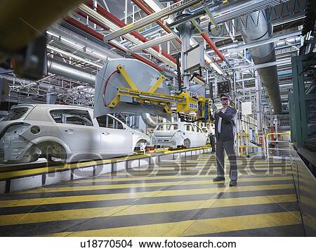 Car Plant Worker With Machinery View Large Photo Image Picture - Car Plant Worker With Machinery. Fotosearch