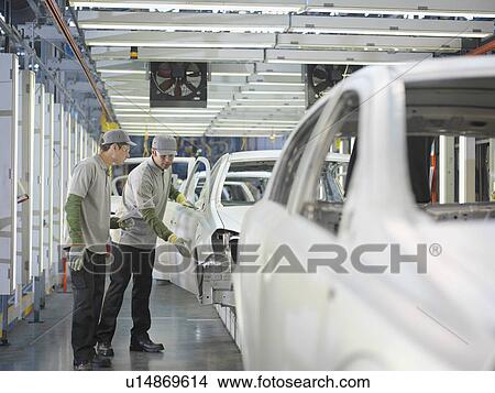 Picture - Car Plant Workers Discussing Cars. Fotosearch