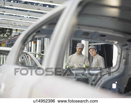 Car Plant Workers Discussing Cars View Large Photo Image Stock Photograph - Car Plant Workers Discussing Cars. Fotosearch
