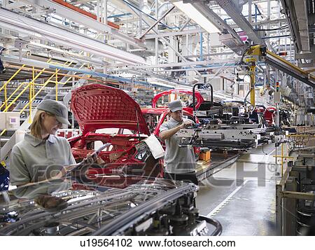 Stock Image - Car Plant Workers On Production Line. Fotosearch