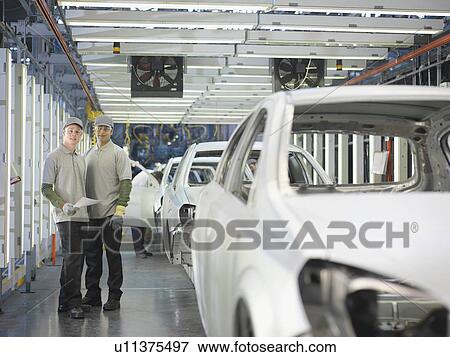 Stock Photo - Car Plant Workers On Production Line. Fotosearch