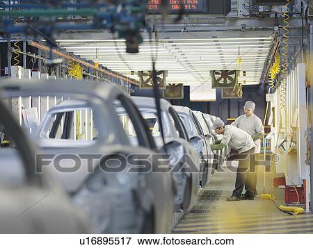 Stock Photo - Car Plant Workers On Production Line. Fotosearch