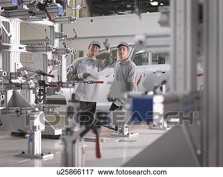 Stock Photo - Car Plant Workers On Production Line. Fotosearch