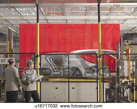 Stock Image - Car Plant Workers & Production Line. Fotosearch