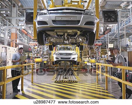 Stock Photo - Car Workers Inspecting Production Line. Fotosearch
