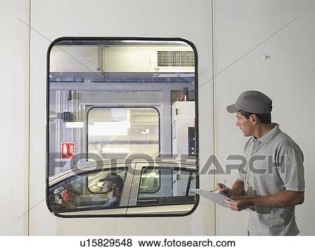 Stock Photo - Car Workers With Newly Completed Car. Fotosearch