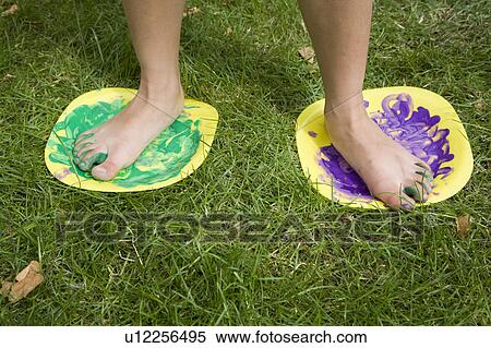 Stock Photography - Child feet painting. Fotosearch