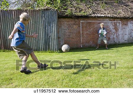 Child footballer shooting at goal View Large Photo Image Stock Image - Child footballer shooting at goal. Fotosearch