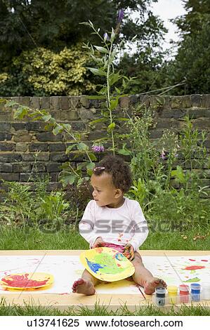 Child painting in the garden View Large Photo Image Stock Photography - Child painting in the garden. Fotosearch