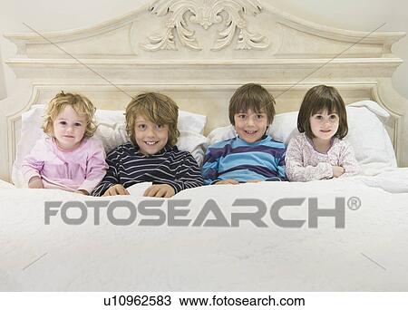 Children in bed together View Large Photo Image Stock Image - Children in bed together. Fotosearch
