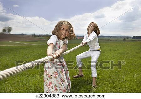 Children pulling a rope in countryside View Large Photo Image Stock Image - Children pulling a rope in countryside. Fotosearch