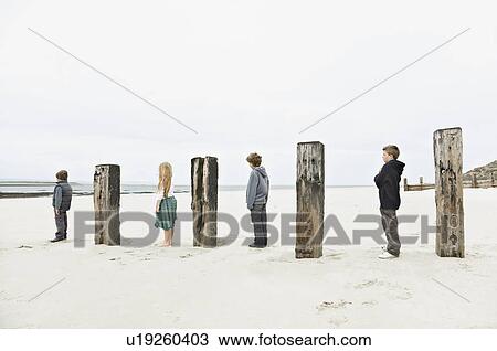 Children standing between posts View Large Photo Image Stock Image - Children standing between posts. Fotosearch