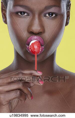 Close-up of woman sucking lollipop View Large Photo Image Stock Photography - Close-up of woman sucking lollipop. Fotosearch