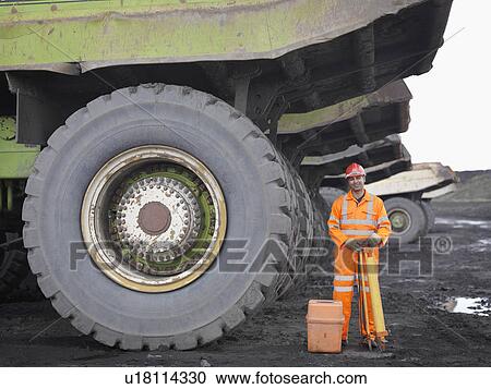 Stock Image - Coal Miner With Surveying Equipment. Fotosearch