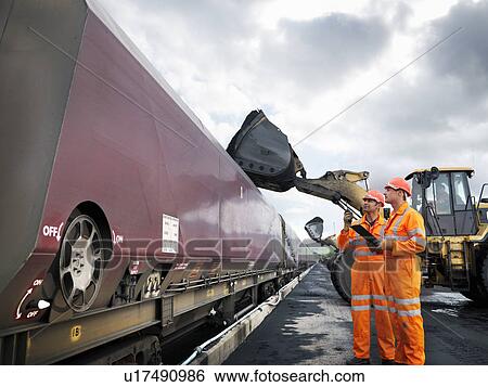 Stock Photograph - Coal Miners Inspecting Coal Train. Fotosearch