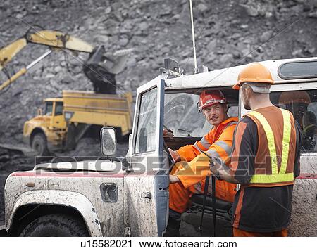 Stock Image - Coal Miners With Landrover In Mine. Fotosearch