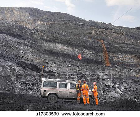 Stock Image - Coal Miners With Landrover In Mine. Fotosearch