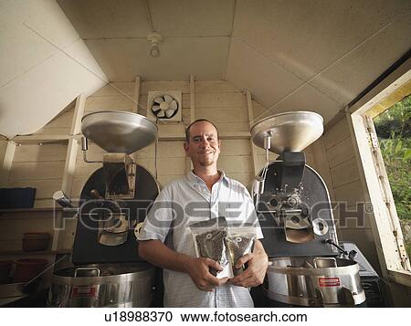 Coffee Worker With Packaged Coffee Beans View Large Photo Image Stock Image - Coffee Worker With Packaged Coffee Beans. Fotosearch