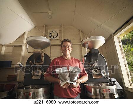 Stock Image - Coffee Worker With Packaged Coffee Beans. Fotosearch