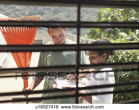 Stock Photo - Coffee Workers Discussing Notes. Fotosearch