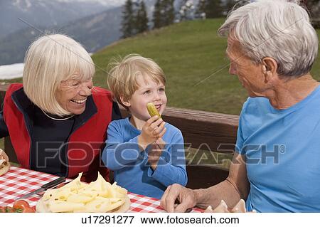 couple and grandson eating in mountains View Large Photo Image Stock Photo - couple and grandson eating in mountains. Fotosearch