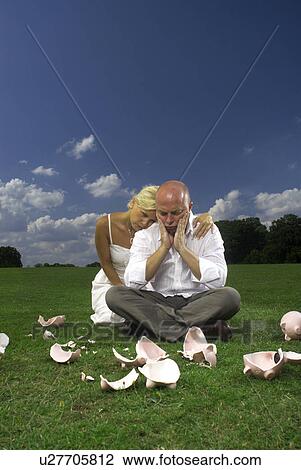 Stock Image - couple and smashed piggy banks. Fotosearch