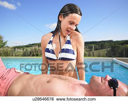 Stock Photo - couple by pool. Fotosearch