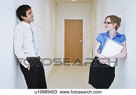 Stock Image - couple chatting in corridor. Fotosearch