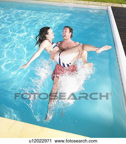 couple falling into pool View Large Photo Image Stock Image - couple falling into pool. Fotosearch