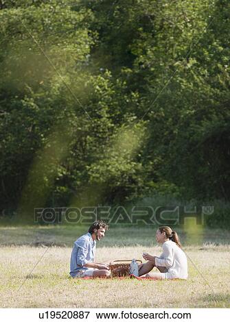 Stock Photo - Couple having a picnic in countryside. Fotosearch