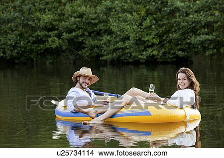 Picture - Couple in dinghy on a country lake. Fotosearch