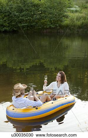 Couple in dinghy on a country lake View Large Photo Image Stock Image - Couple in dinghy on a country lake. Fotosearch