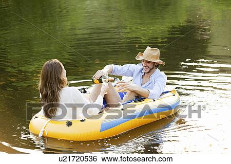 Couple in dinghy on a country lake View Large Photo Image Stock Photograph - Couple in dinghy on a country lake. Fotosearch