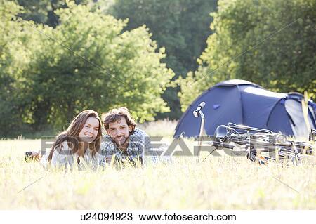 Couple laying in grass in country scene View Large Photo Image Stock Image - Couple laying in grass in country scene. Fotosearch