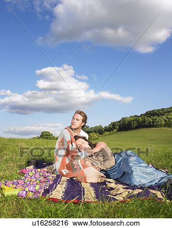 couple lying in field View Large Photo Image Stock Photograph - couple lying in field. Fotosearch