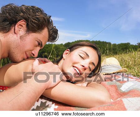 Stock Photograph - couple on blanket in field. Fotosearch