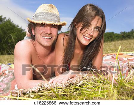 Stock Photograph - couple on blanket in field. Fotosearch