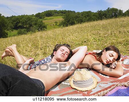 Stock Photography - couple on blanket in field. Fotosearch