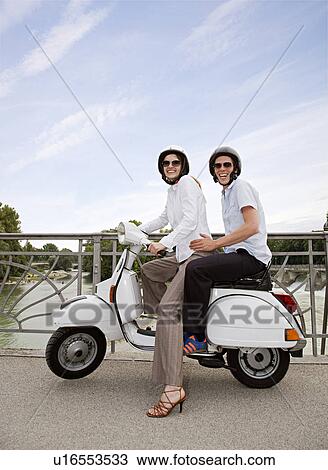 couple on scooter on bridge View Large Photo Image Stock Image - couple on scooter on bridge. Fotosearch
