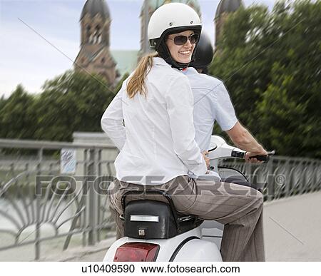 Stock Image - couple on scooter. Fotosearch