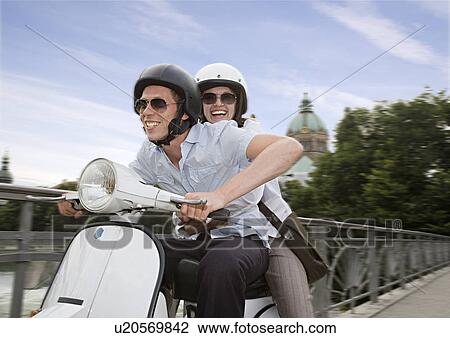 Stock Image - couple on scooter. Fotosearch
