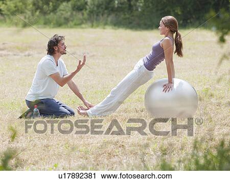 couple on yoga ball stretching View Large Photo Image Stock Image - couple on yoga ball stretching. Fotosearch