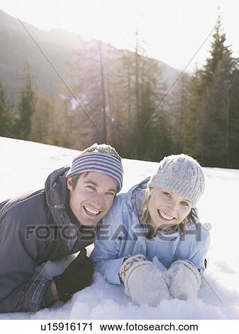 couple playing in the snow View Large Photo Image Stock Image - couple playing in the snow. Fotosearch