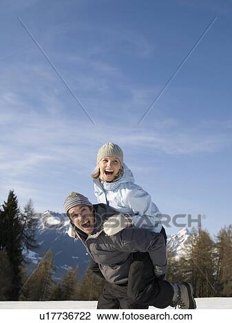 couple playing in the snow View Large Photo Image Stock Image - couple playing in the snow. Fotosearch