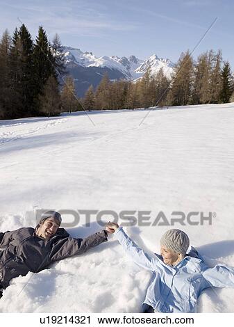 couple playing in the snow View Large Photo Image Stock Image - couple playing in the snow. Fotosearch
