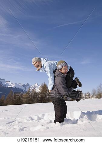 Stock Image - couple playing in the snow. Fotosearch