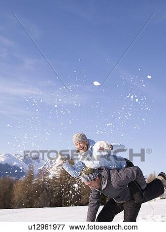 couple playing in the snow View Large Photo Image Stock Photo - couple playing in the snow. Fotosearch